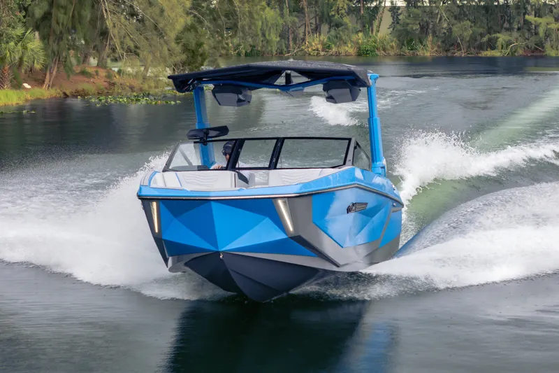  Yacht Photos Pics 2026 Nautique Super Air Nautique G23 in motion on a scenic waterway.