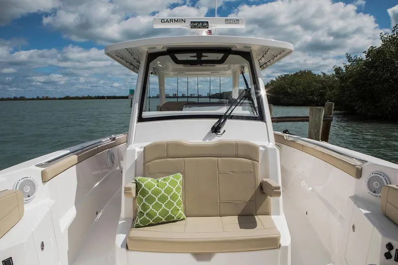 Amuninni Yacht Photos Pics Manufacturer Provided Image: 2021 Pursuit S 328 Sport boat interior with beige seating and green pillow.