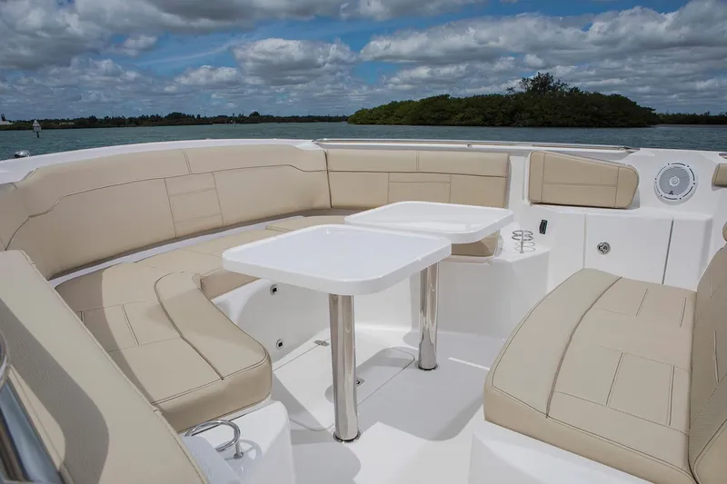 Amuninni Yacht Photos Pics Manufacturer Provided Image: 2021 Pursuit S 328 Sport boat with beige seating and dual tables on deck.