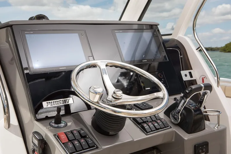 Amuninni Yacht Photos Pics Manufacturer Provided Image: 2021 Pursuit S 328 Sport boat dashboard with dual screens and steering wheel.
