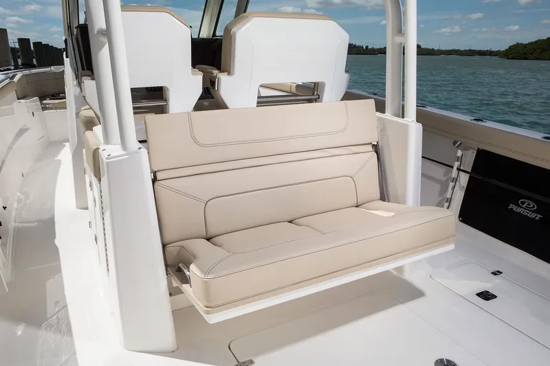 Amuninni Yacht Photos Pics Manufacturer Provided Image: 2021 Pursuit S 328 Sport boat with beige seating and ocean backdrop.