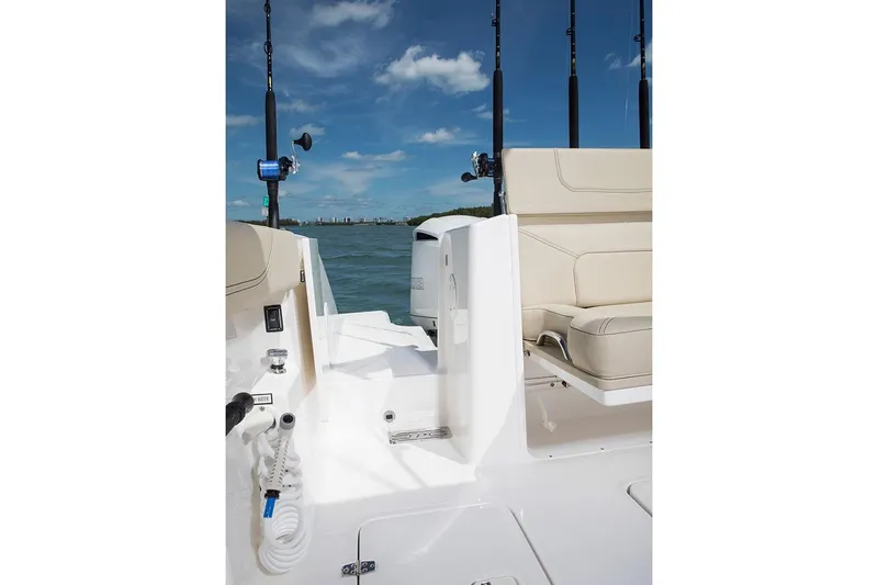 Amuninni Yacht Photos Pics Manufacturer Provided Image: 2021 Pursuit S 328 Sport boat interior with beige seating and fishing rods.
