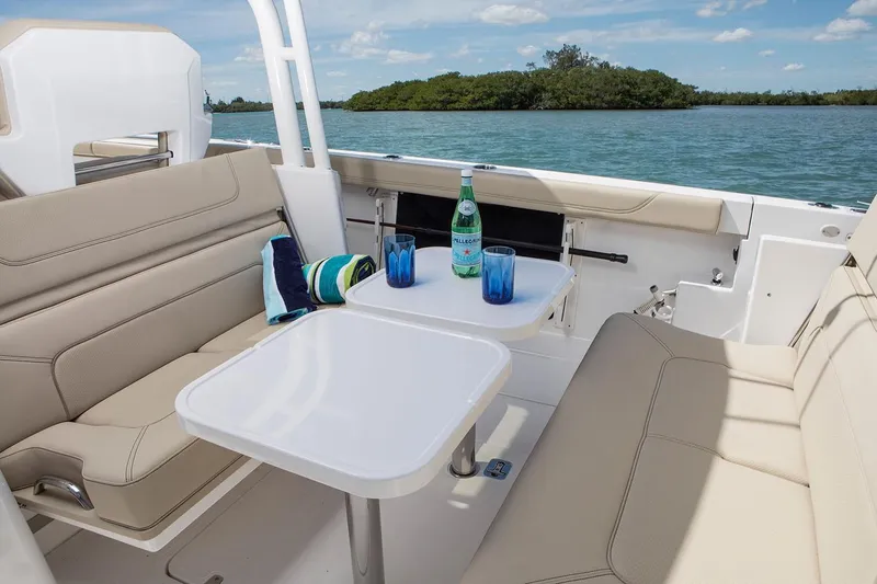 Amuninni Yacht Photos Pics Manufacturer Provided Image: 2021 Pursuit S 328 Sport boat interior with seating and table on the water.