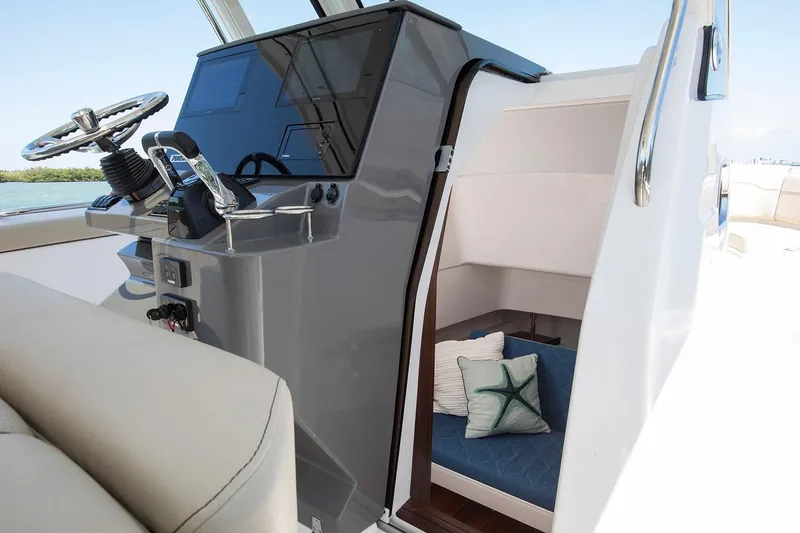 Amuninni Yacht Photos Pics Manufacturer Provided Image: 2021 Pursuit S 328 Sport boat interior with helm and cabin.