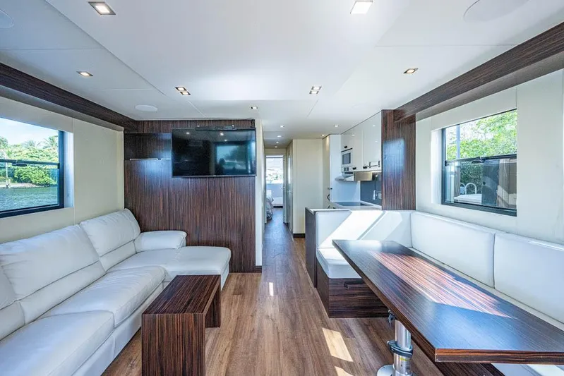  Yacht Photos Pics Modern interior of 2017 Overblue 44 Powercat with white leather seating and wood accents.