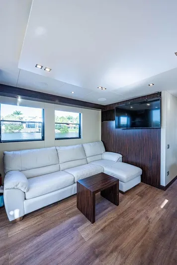  Yacht Photos Pics Modern interior of 2017 Overblue 44 Powercat with white sofa and flat-screen TV.