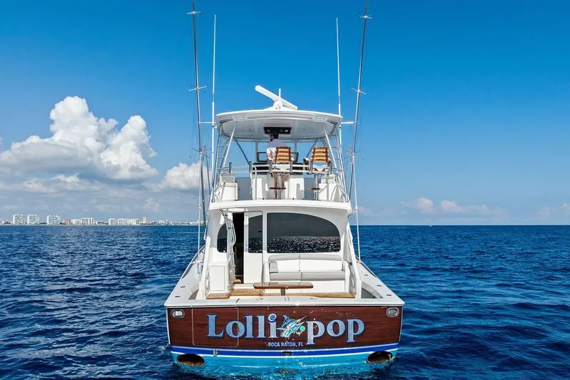 Lollipop Yacht Photos Pics 2022 Viking 48 Convertible yacht on open sea, clear sky, rear view.