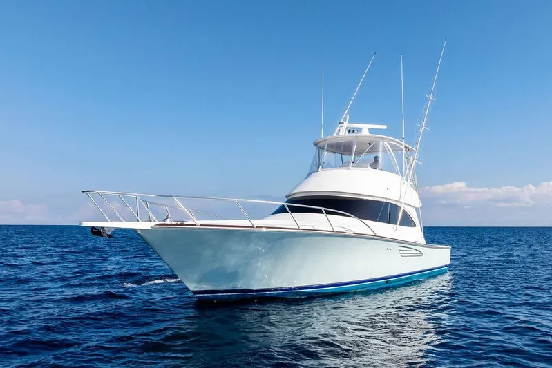 Lollipop Yacht Photos Pics 2022 Viking 48 Convertible yacht cruising on open sea under clear blue sky.