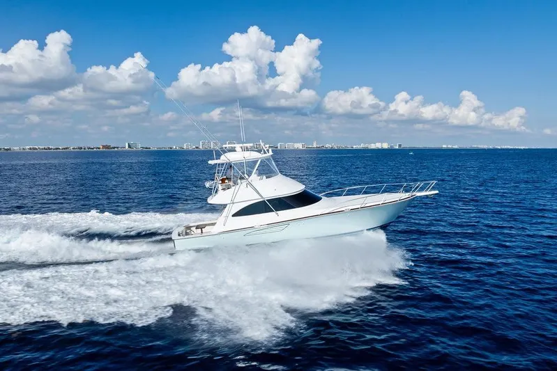 Lollipop Yacht Photos Pics 2022 Viking 48 Convertible yacht cruising on open ocean under blue sky.