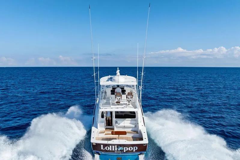Lollipop Yacht Photos Pics 2022 Viking 48 Convertible yacht cruising on open ocean waters.