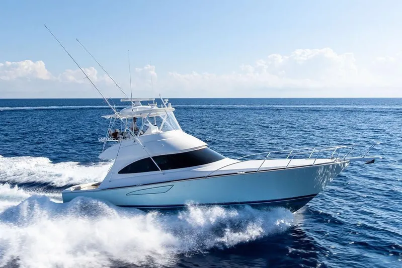 Lollipop Yacht Photos Pics 2022 Viking 48 Convertible yacht cruising on open sea under clear skies.