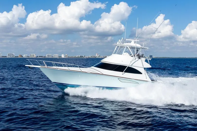 Lollipop Yacht Photos Pics 2022 Viking 48 Convertible yacht cruising on open sea under blue sky.