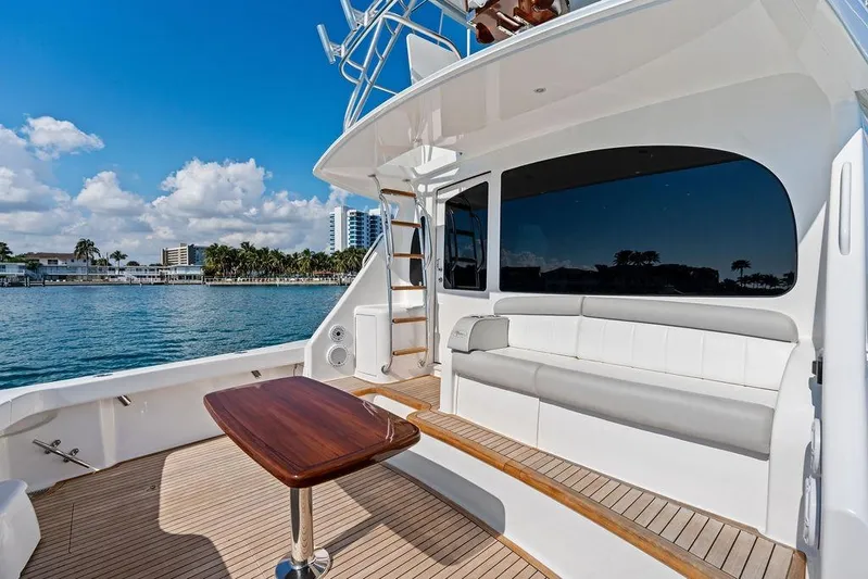 Lollipop Yacht Photos Pics 2022 Viking 48 Convertible yacht with spacious deck, luxurious seating, and ocean view.