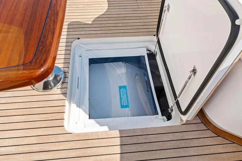 Lollipop Yacht Photos Pics Open hatch on 2022 Viking 48 Convertible yacht deck, showcasing storage compartment.