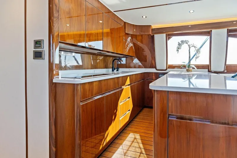 Lollipop Yacht Photos Pics Luxurious kitchen interior of 2022 Viking 48 Convertible yacht with wood finish and modern design.