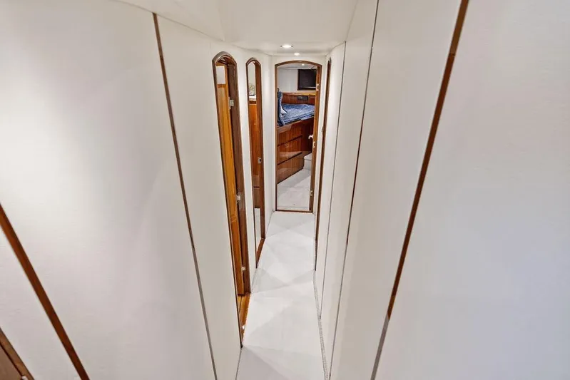 Lollipop Yacht Photos Pics Interior hallway of 2022 Viking 48 Convertible yacht, featuring sleek design and wood accents.