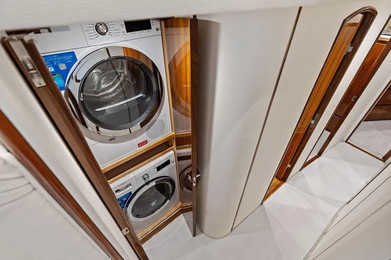 Lollipop Yacht Photos Pics Laundry area inside 2022 Viking 48 Convertible yacht with stacked washer and dryer.