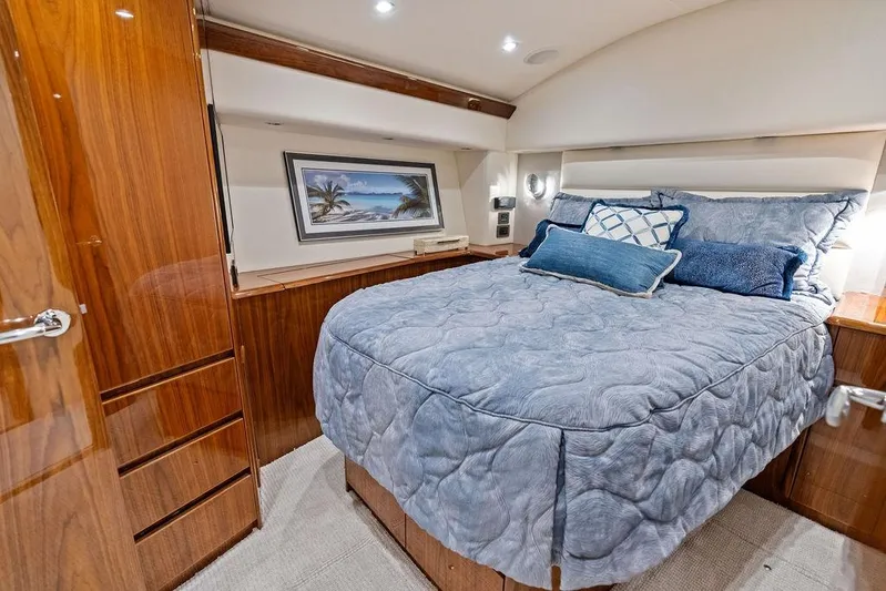 Lollipop Yacht Photos Pics Luxurious bedroom interior of 2022 Viking 48 Convertible yacht with elegant wood finishes.