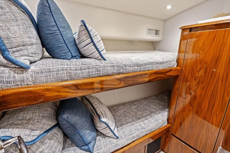 Lollipop Yacht Photos Pics 2022 Viking 48 Convertible yacht interior with cozy bunk beds and plush pillows.
