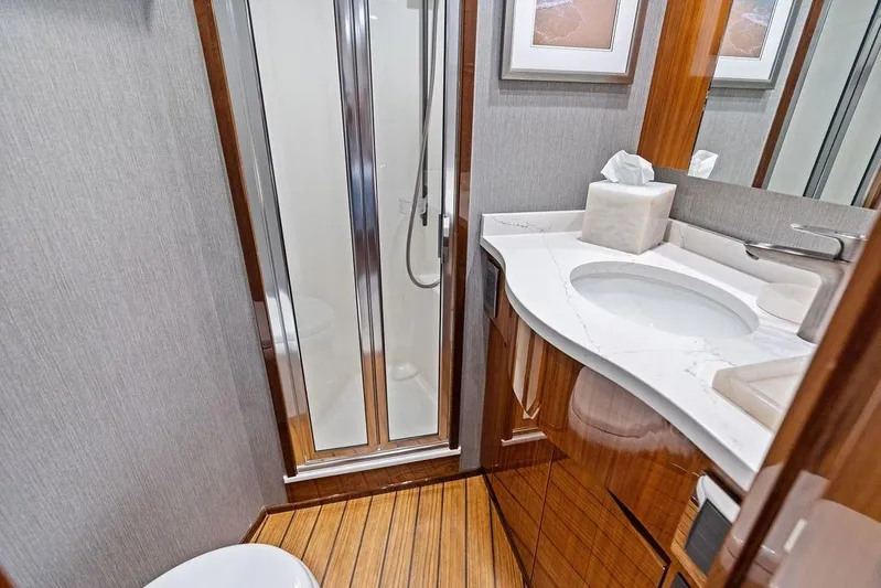 Lollipop Yacht Photos Pics Luxurious bathroom in 2022 Viking 48 Convertible yacht with modern fixtures and wood accents.