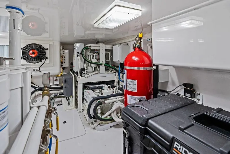 Lollipop Yacht Photos Pics Engine room of 2022 Viking 48 Convertible yacht with fire extinguisher and equipment.
