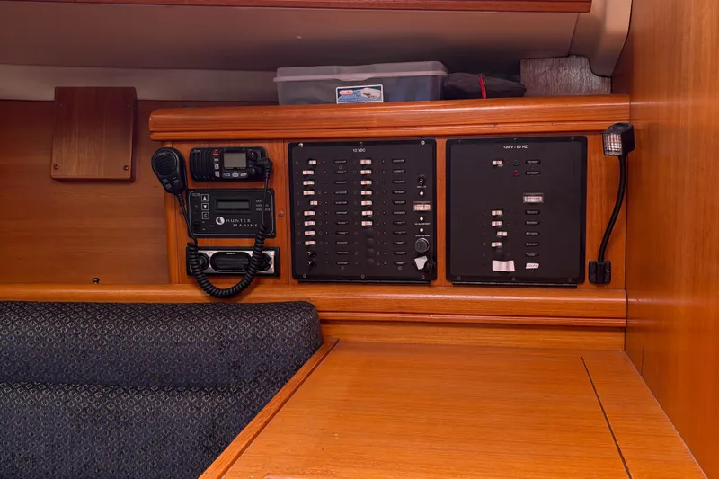 Kokua Yacht Photos Pics Control panel inside a 2004 Hunter 33 sailboat, featuring communication and electrical systems.