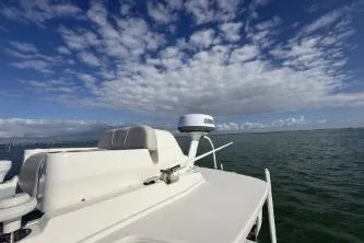  Yacht Photos Pics 2024 SeaVee 270Z boat on open water under a partly cloudy sky.