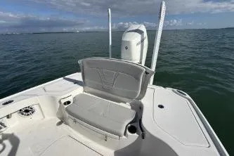  Yacht Photos Pics 2024 SeaVee 270Z boat with seating, on calm ocean waters under a partly cloudy sky.