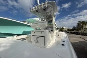  Yacht Photos Pics 2024 SeaVee 270Z boat with center console, docked under a partly cloudy sky.