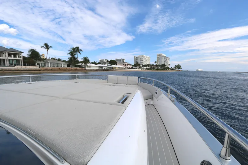 Momentum Yacht Photos Pics 2023 Azimut 47 VERVE yacht cruising near coastal cityscape under blue sky.