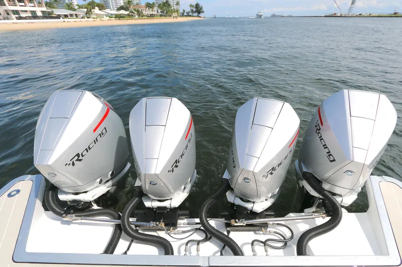 Momentum Yacht Photos Pics Four powerful outboard engines on a 2023 Azimut 47 VERVE yacht, docked by the shore.