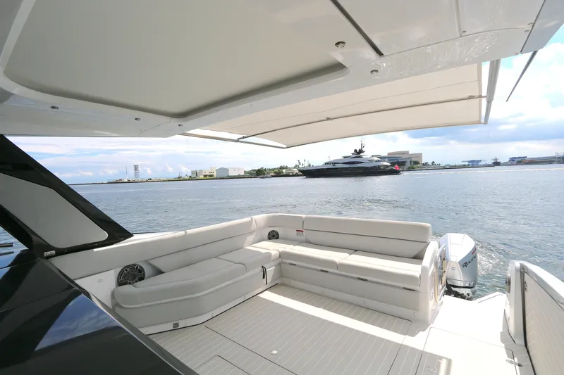 Momentum Yacht Photos Pics Luxurious 2023 Azimut 47 VERVE yacht deck with spacious seating and scenic waterfront view.