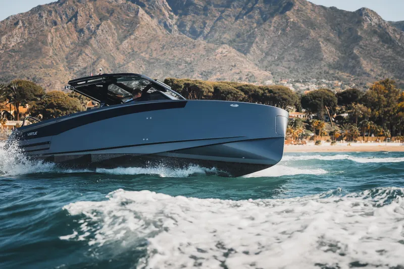  Yacht Photos Pics 2026 Virtue V10 T-Top boat cruising on ocean with scenic mountain backdrop.
