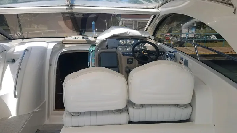 Instant Karma Yacht Photos Pics Interior of 2002 Maxum 4200 SY yacht with white seating and control panel.