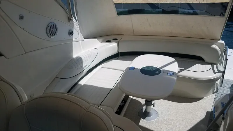 Instant Karma Yacht Photos Pics Luxurious seating area on 2002 Maxum 4200 SY yacht with elegant white upholstery.