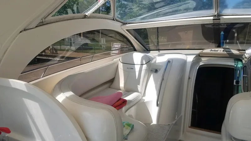 Instant Karma Yacht Photos Pics Interior of 2002 Maxum 4200 SY yacht with white seating and open cabin door.