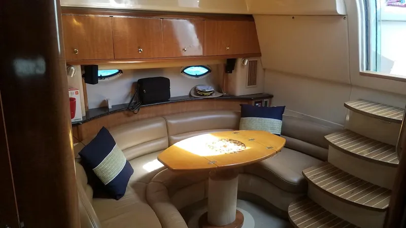 Instant Karma Yacht Photos Pics Luxurious 2002 Maxum 4200 SY yacht interior with cozy seating and elegant wood finishes.