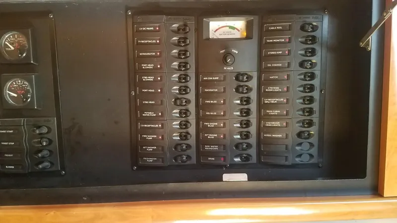 Instant Karma Yacht Photos Pics Control panel of a 2002 Maxum 4200 SY boat with switches and gauges.