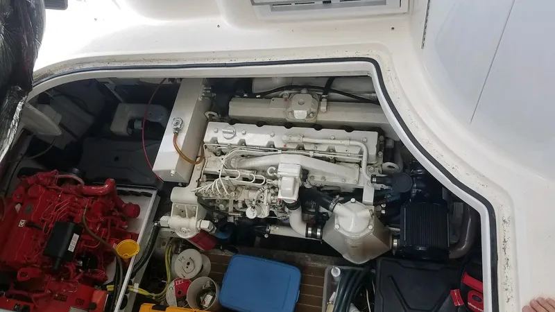 Instant Karma Yacht Photos Pics Engine compartment of a 2002 Maxum 4200 SY boat, showing mechanical components and tools.