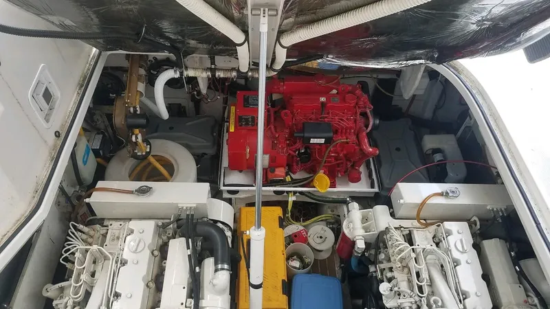 Instant Karma Yacht Photos Pics Engine compartment of 2002 Maxum 4200 SY boat with visible machinery and components.