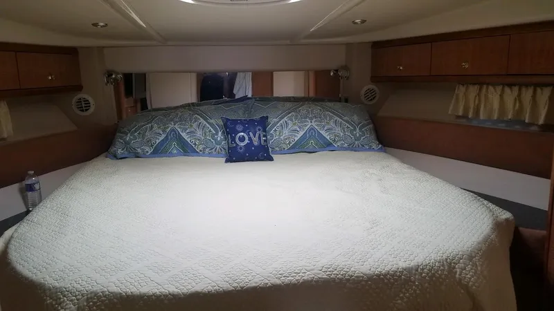 Instant Karma Yacht Photos Pics Luxurious bedroom interior of 2002 Maxum 4200 SY yacht with cozy bedding.