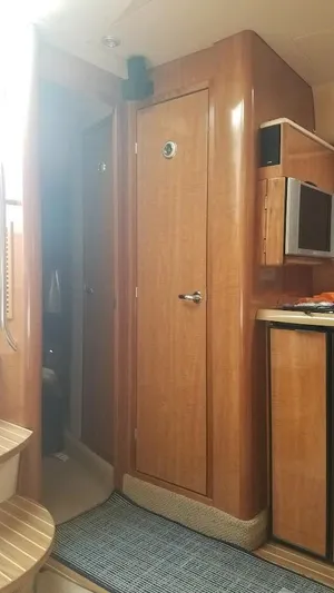 Instant Karma Yacht Photos Pics Interior of 2002 Maxum 4200 SY yacht with wooden cabinetry and modern amenities.