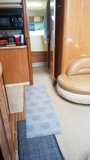 Instant Karma Yacht Photos Pics Interior of 2002 Maxum 4200 SY yacht with wood paneling and seating area.