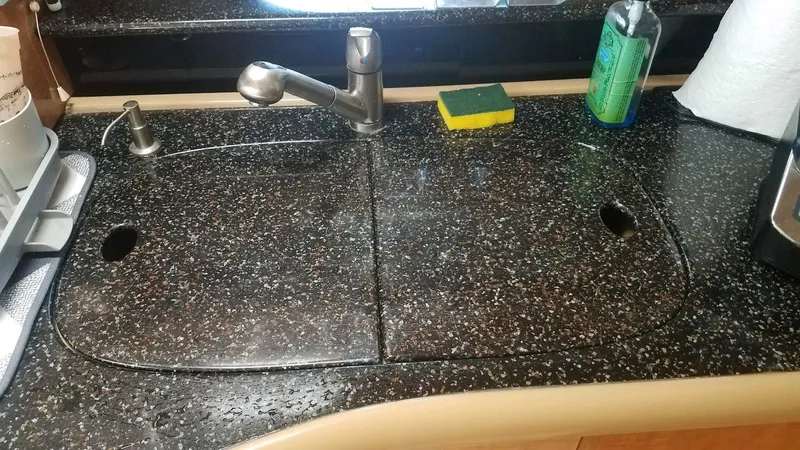 Instant Karma Yacht Photos Pics Granite countertop with sink and faucet in 2002 Maxum 4200 SY yacht kitchen.