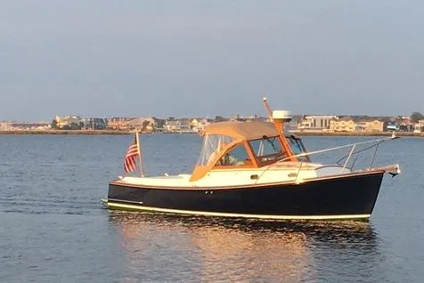Virginia Yacht Photos Pics 2010 C.W. Hood WASQUE 26 boat on calm water with coastal background.