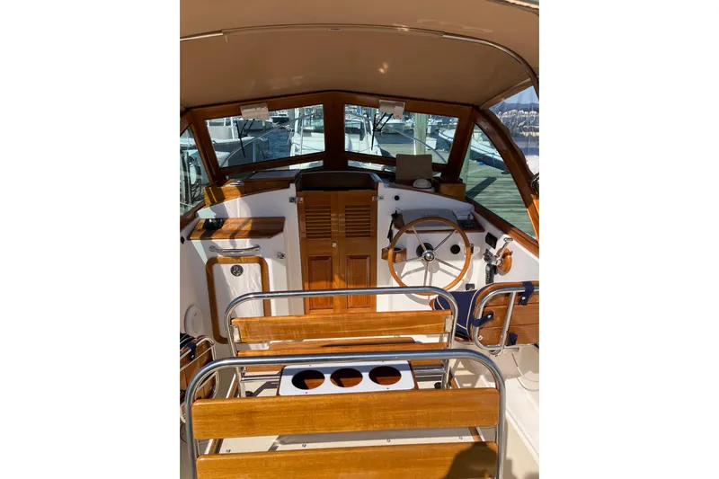 Virginia Yacht Photos Pics 2010 C.W. Hood WASQUE 26 boat interior with wooden steering wheel and seating.