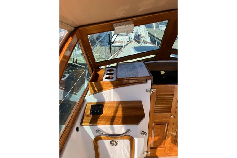 Virginia Yacht Photos Pics Interior of 2010 C.W. Hood WASQUE 26 boat with wooden accents and navigation map.