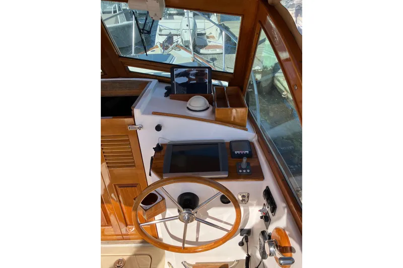 Virginia Yacht Photos Pics Helm of 2010 C.W. Hood WASQUE 26 boat with wooden steering wheel and navigation equipment.