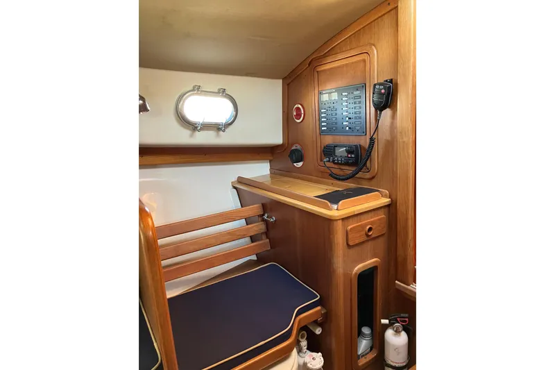 Virginia Yacht Photos Pics Interior of 2010 C.W. Hood WASQUE 26 boat with wooden paneling and control panel.