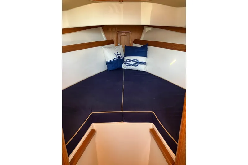 Virginia Yacht Photos Pics Cozy cabin interior of 2010 C.W. Hood WASQUE 26 with nautical-themed pillows.